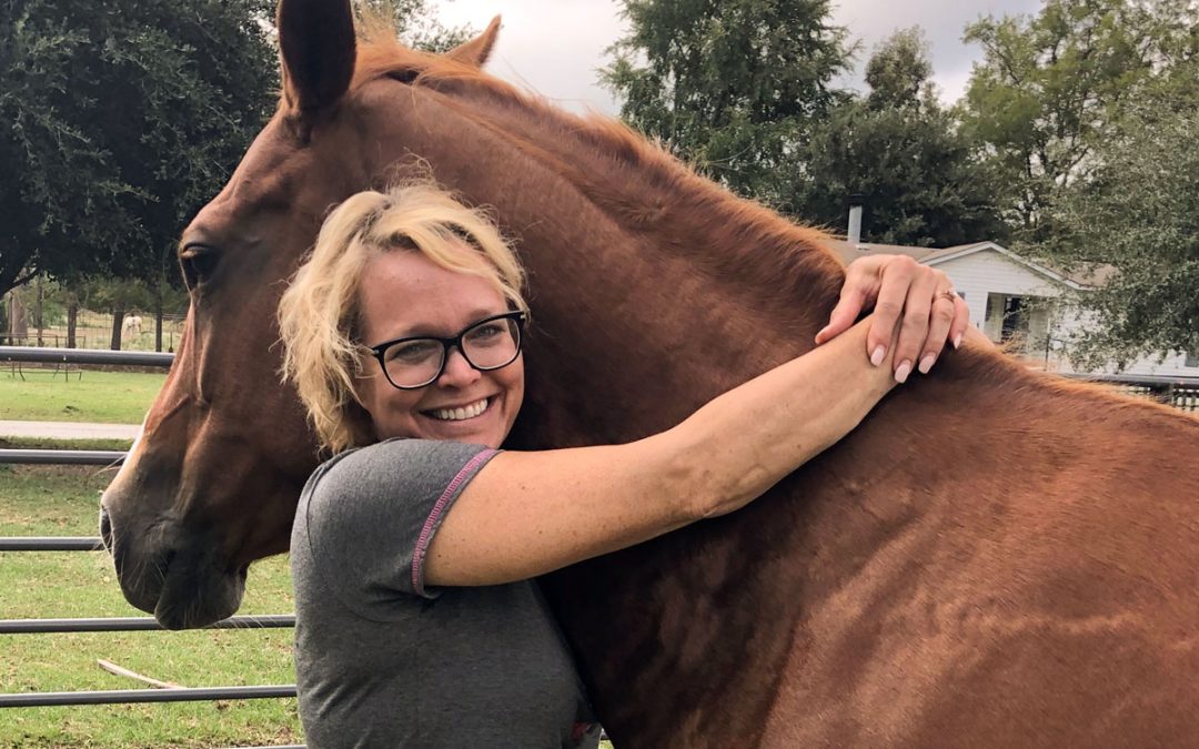 Kathleen hugging her horse